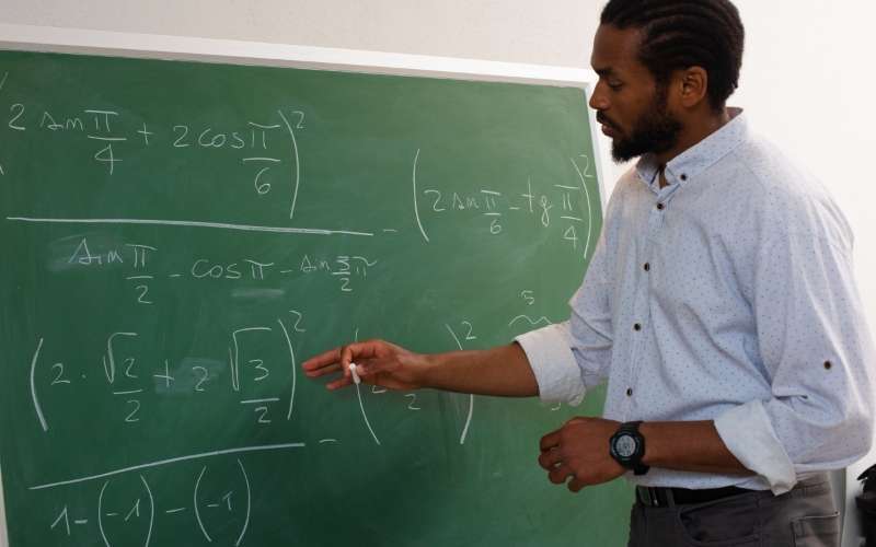 Student studying logic and mathematics for TMUA exam preparation